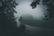 An Asphalt Road That Goes Through A Misty Dark Misterious Forest Royalty Free Stock Photo