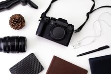 Top View Desk Workspace With Hipster Photo Camera, Lens, Headphones, Notepad For Writing With Black Pen On White Royalty Free Stock Image