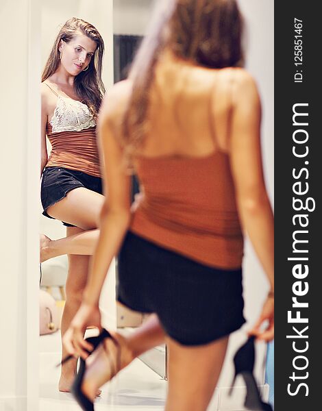 Picture of woman thinking what to dress in walk-in closet. Picture of woman thinking what to dress in walk-in closet