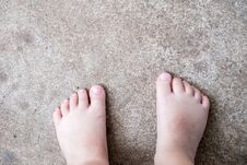 View From Above Of Barefoot Child With Dirty Feet Standing On Con Royalty Free Stock Photo