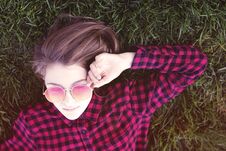 Teenage Girl Laying On Grass In Park In Sunglasses Royalty Free Stock Photo