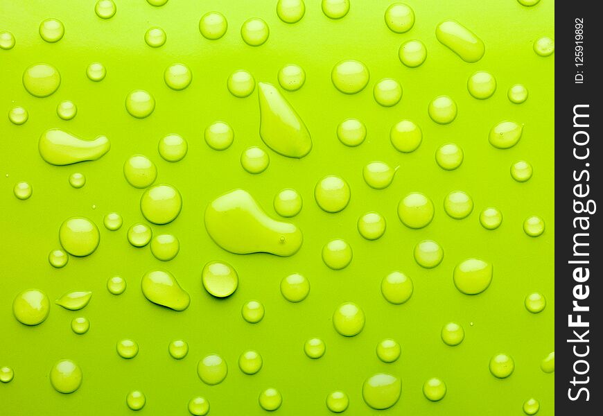 Macro of water drops on green surface