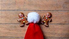 Gingerbread Cookie And Santa Claus Hat Royalty Free Stock Image
