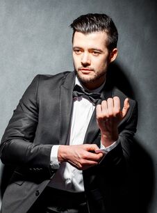 Free Portrait Of Confident Handsome Man In Black Suit With Bowtie Stock Photos - 125935243