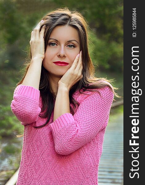 Beautiful colourful famale portrait. The girl in the light of thr sunset.