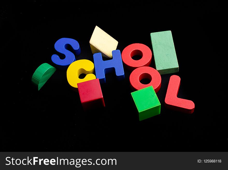 Education concept by School lettering with colorful wooden letters. Education concept by School lettering with colorful wooden letters