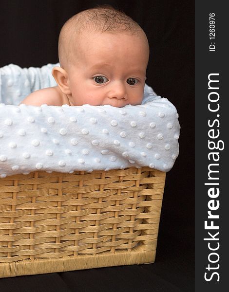 Baby boy sitting in basket. Baby boy sitting in basket