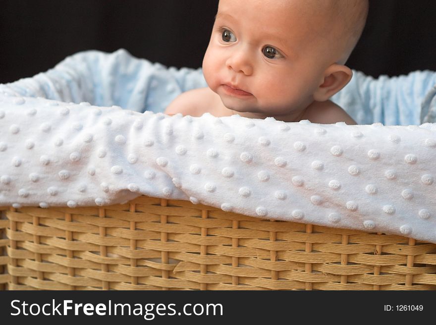 Baby boy sitting in basket. Baby boy sitting in basket