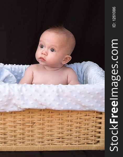 Baby boy sitting in basket. Baby boy sitting in basket