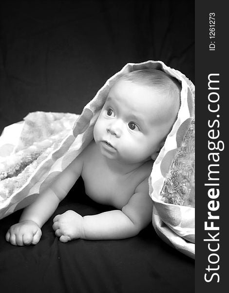 Portrait of baby boy covered by a blanket. Portrait of baby boy covered by a blanket