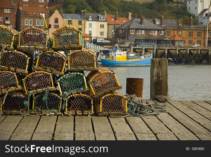 Lobster pots with fishing boat. Lobster pots with fishing boat