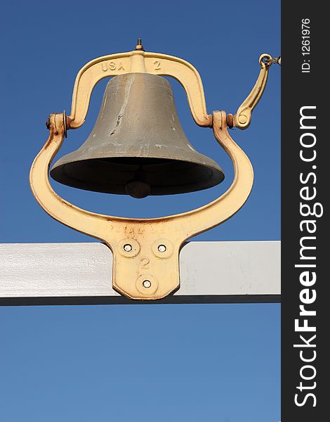 Rustic bell at a lake marina