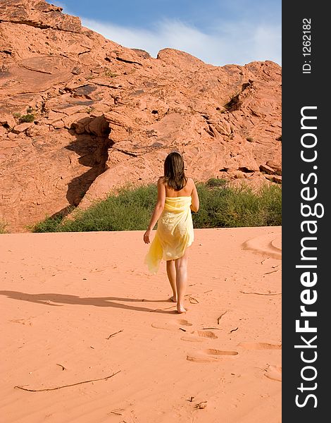 Woman walking on pink sand dunes. Woman walking on pink sand dunes