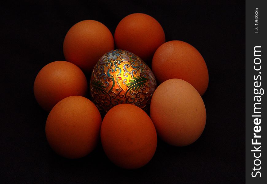 Golden egg with half dozen organic eggs. Golden egg with half dozen organic eggs.