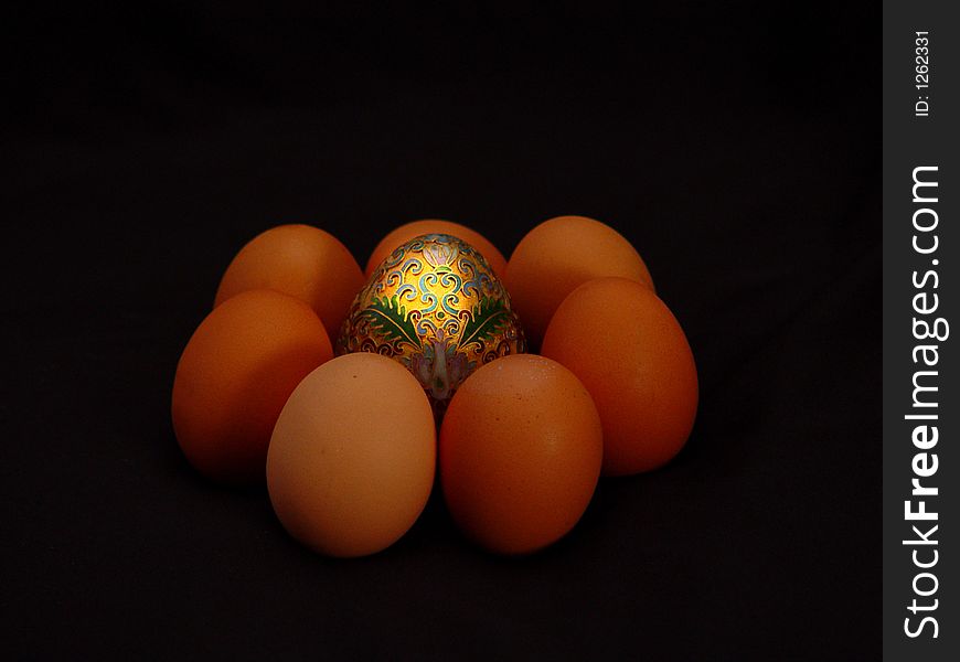 Golden egg with half dozen organic eggs. Golden egg with half dozen organic eggs.