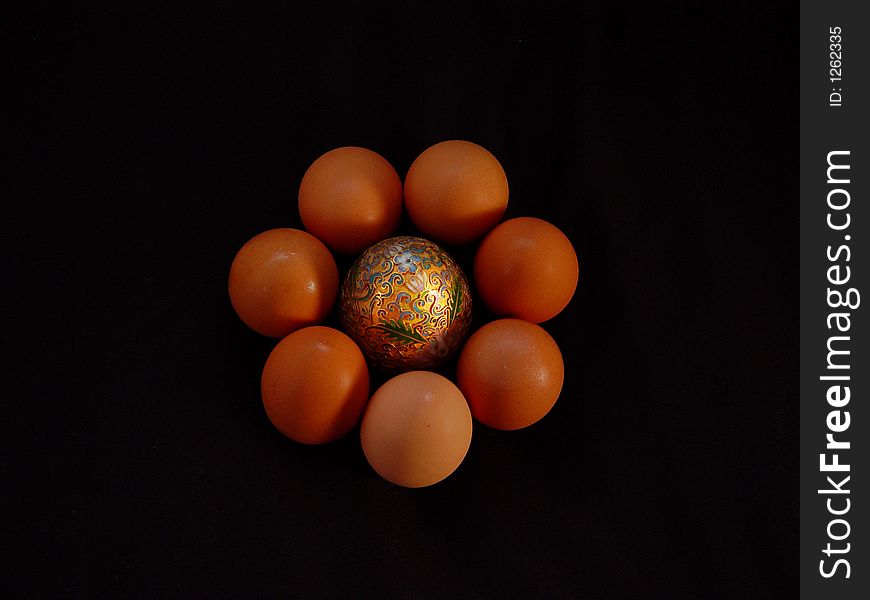 Golden egg with half dozen organic eggs. Golden egg with half dozen organic eggs.