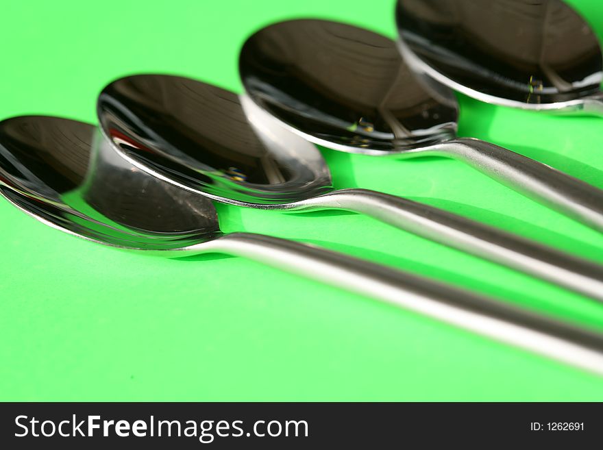 Spoons against a green background