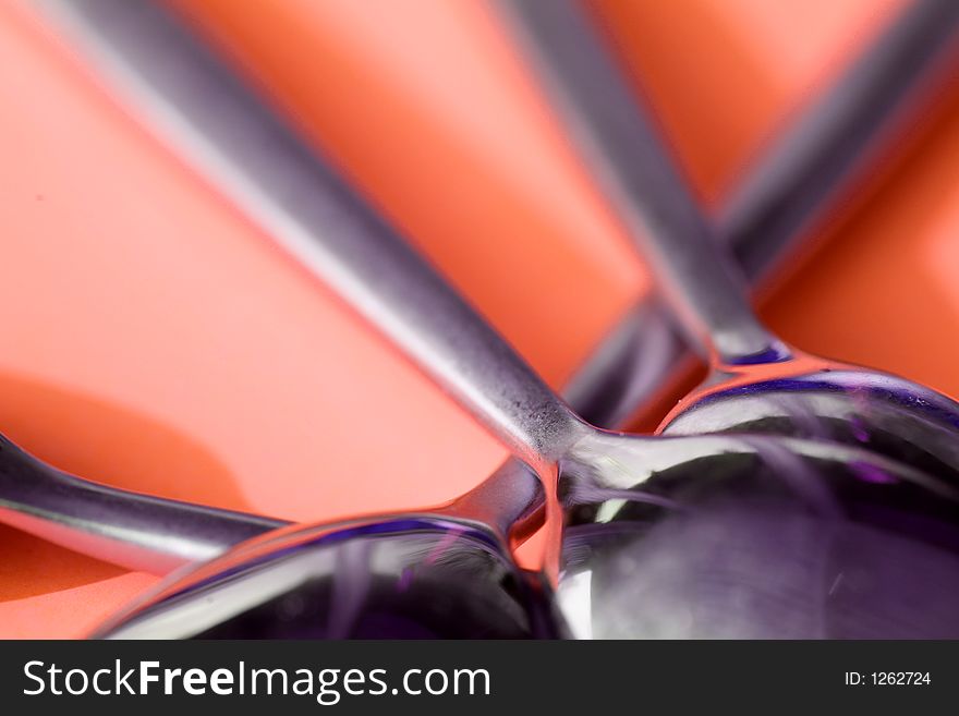 Spoons against a red background