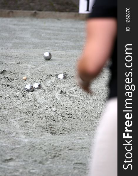 Close up of people at sport,  a woman playing the french petanque. Close up of people at sport,  a woman playing the french petanque