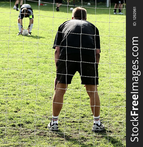 Close up of people at sport, silhouette of a goalkeeper shot from behind. Close up of people at sport, silhouette of a goalkeeper shot from behind