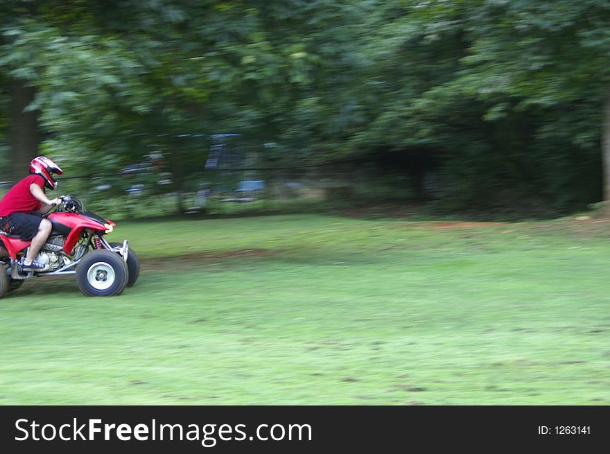 A shot of someone riding an ATV, motion blur. A shot of someone riding an ATV, motion blur