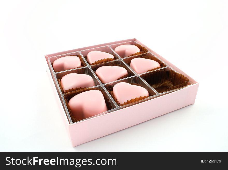 Pink love heart chocolates on a white background