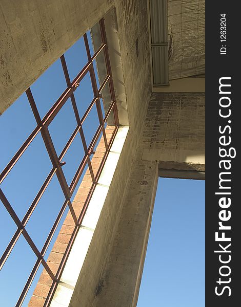 Warehouse window looking out over blue sky