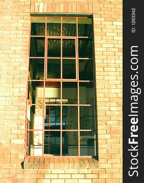 Warehouse window looking out over blue sky