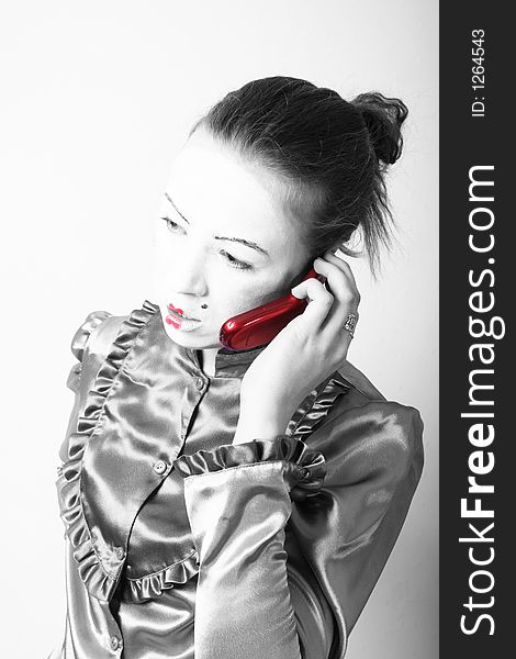 Attractive young tradition girl with red mobile. Good idea for mobilephone advertising. Attractive young tradition girl with red mobile. Good idea for mobilephone advertising.