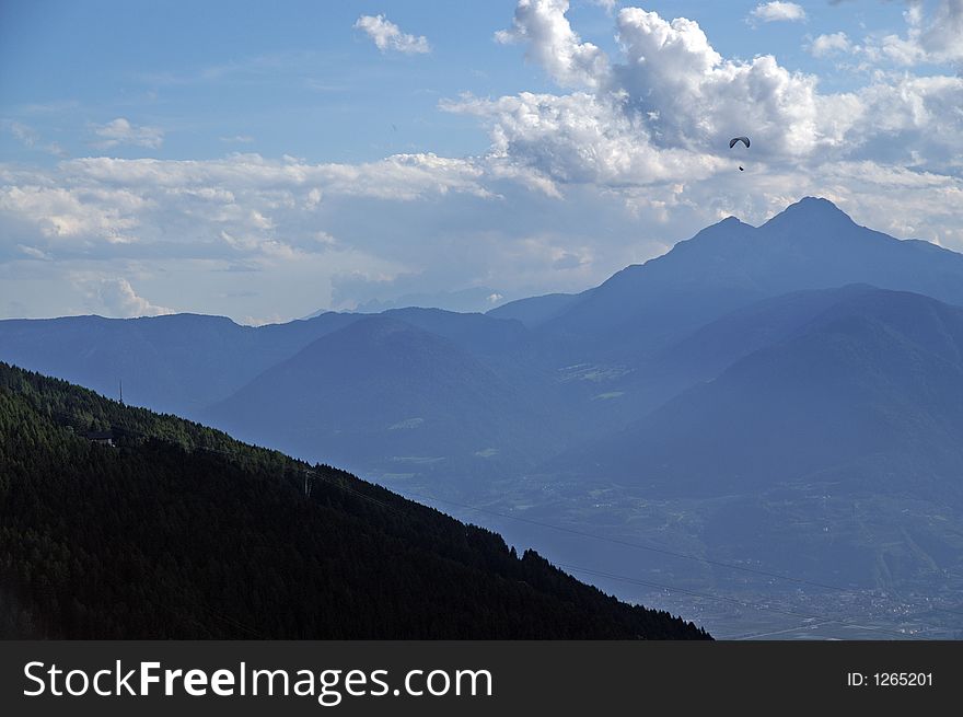 Hang glider in the Alps; hight by the clouds. Hang glider in the Alps; hight by the clouds