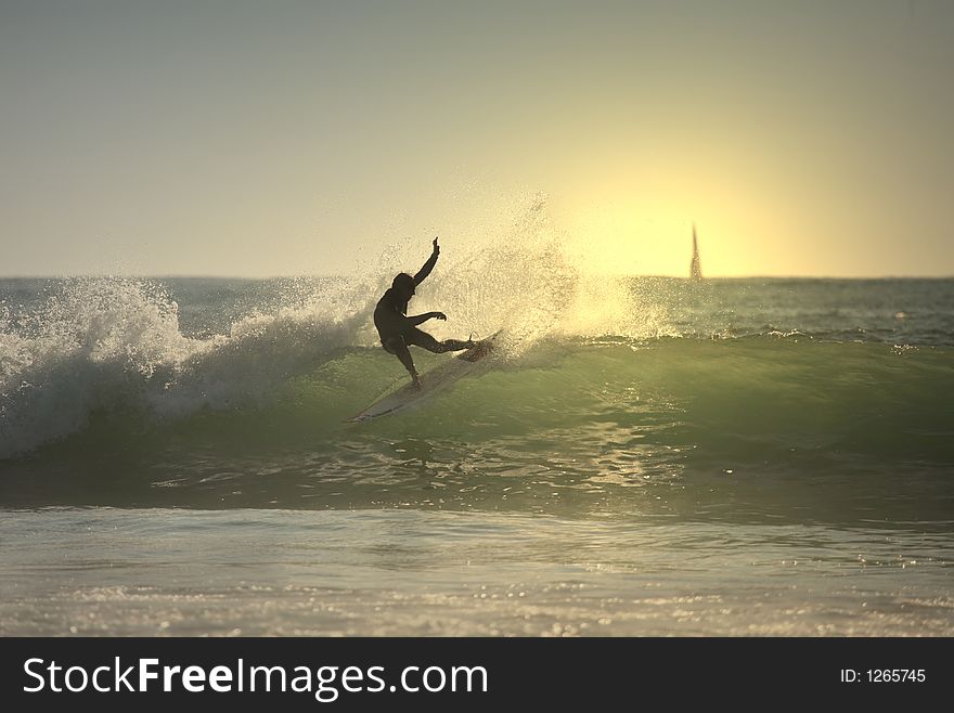 Sunset surfer in the wave