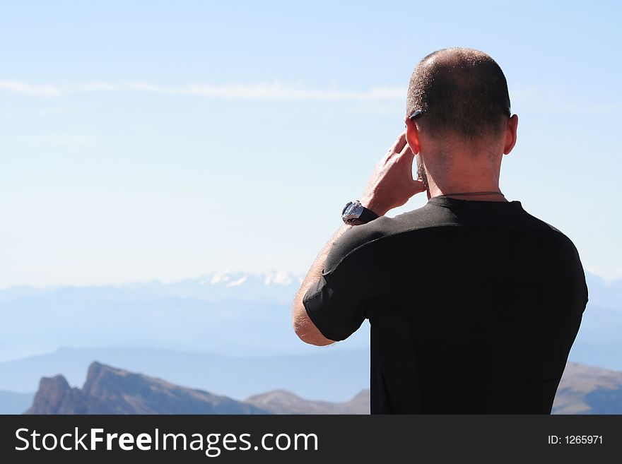 Man takes picture of breathtaking view. Man takes picture of breathtaking view