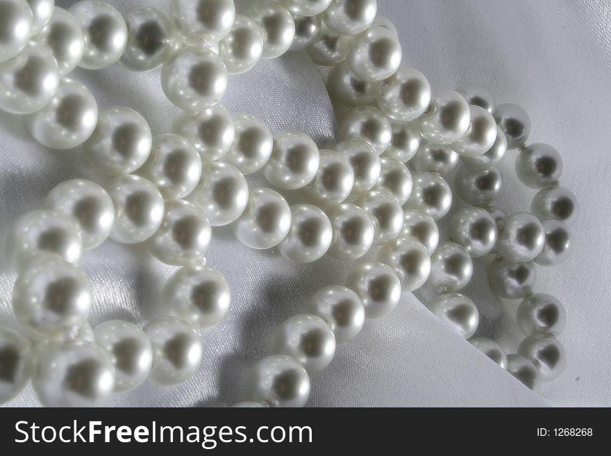 Pearls a necklace on a silk fabric