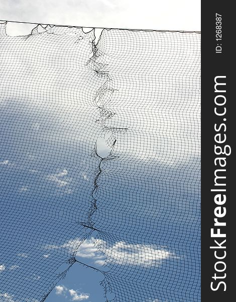 A photograph taken of a net against the blue sky. A photograph taken of a net against the blue sky.