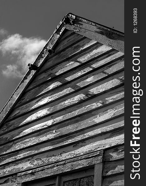 Peak of old wooden building - black and white weatherboards. Peak of old wooden building - black and white weatherboards