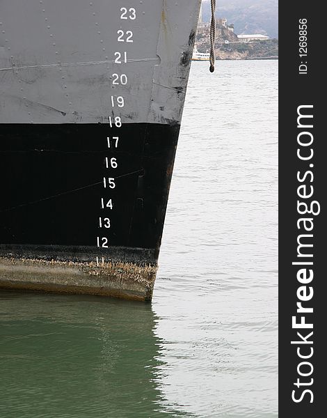 Front of a military boat with numbers and san francisco bay in back ground