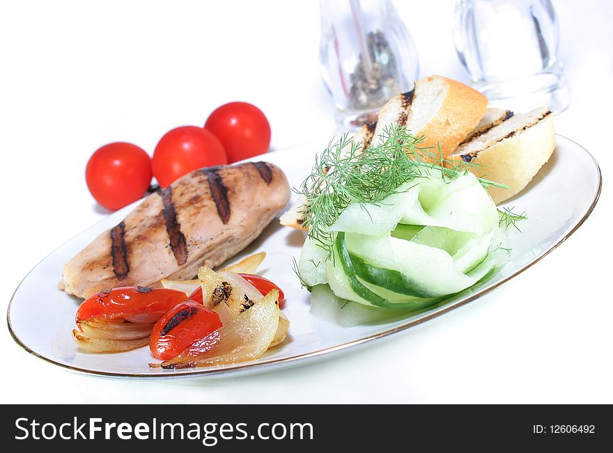 Chicken breast with grilled vegetables and cucumber salad. Chicken breast with grilled vegetables and cucumber salad