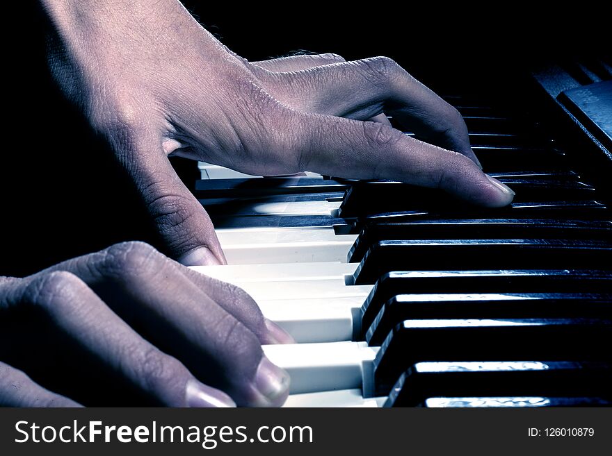 Hands man play piano keys in the dark. Hands man play piano keys in the dark