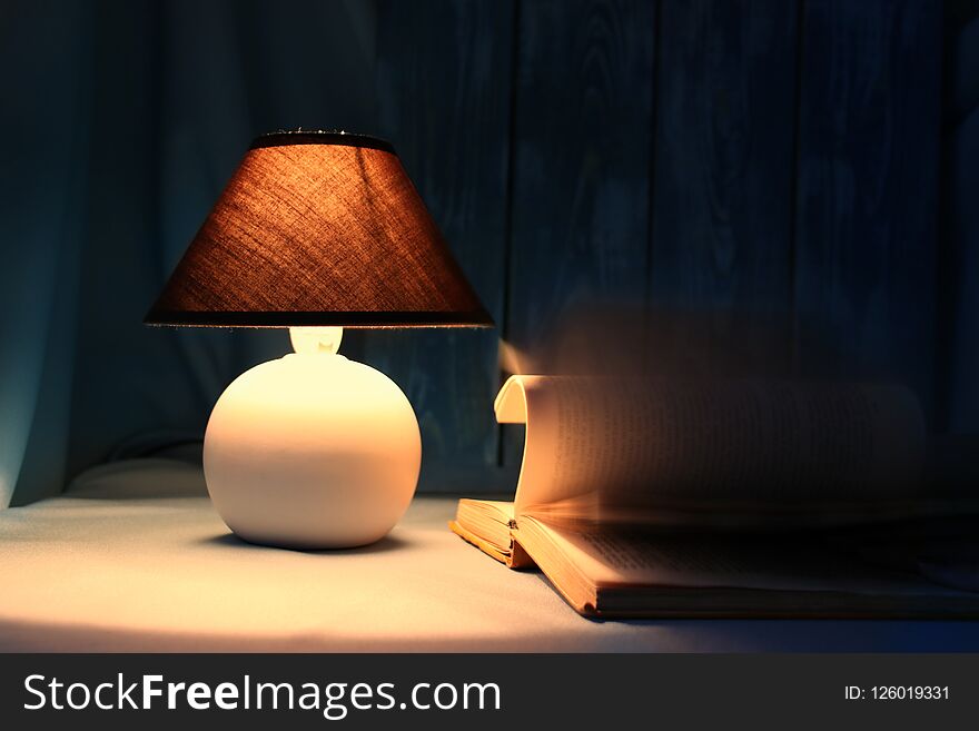 Still-life lamp with a book on a table