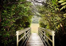 Wooden Bridge Crossing To An Open Meadow Royalty Free Stock Photography