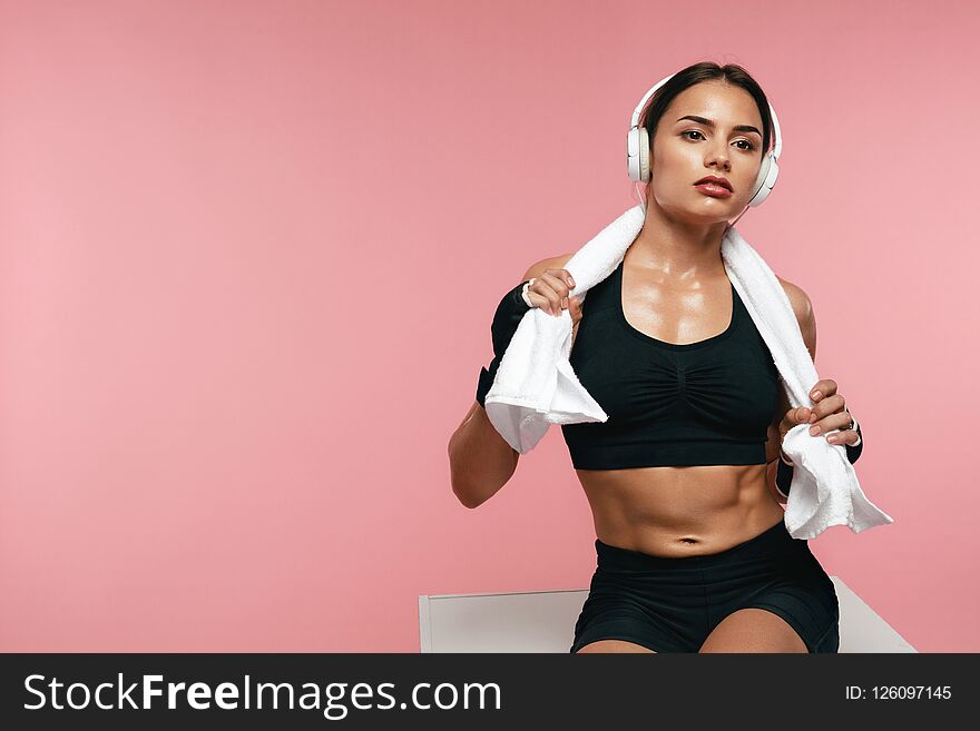 Sport Woman Listening Music In Headphones On Training