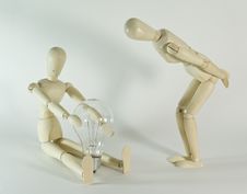 Wooden Figure With Lightbulb Stock Image