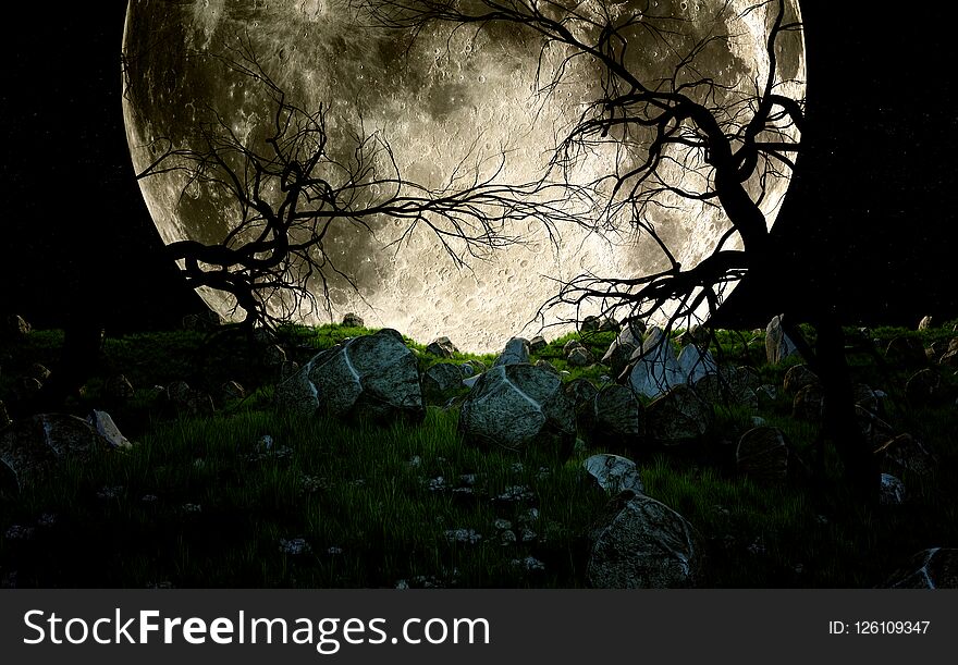 Dead trees at night in rocky field in front of huge moon. Dead trees at night in rocky field in front of huge moon