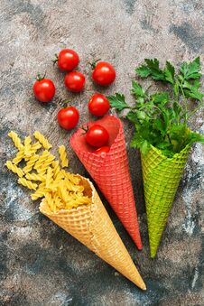Pasta,tomatoes And Parsley In A Waffle Cone From The Ice Cream. The Concept Of Food. The View From The Top,flat Lay. Stock Photo