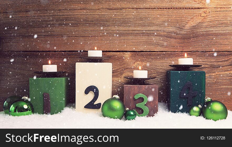 Four candles decorated with christmas balls burning , concepts for fourth advent