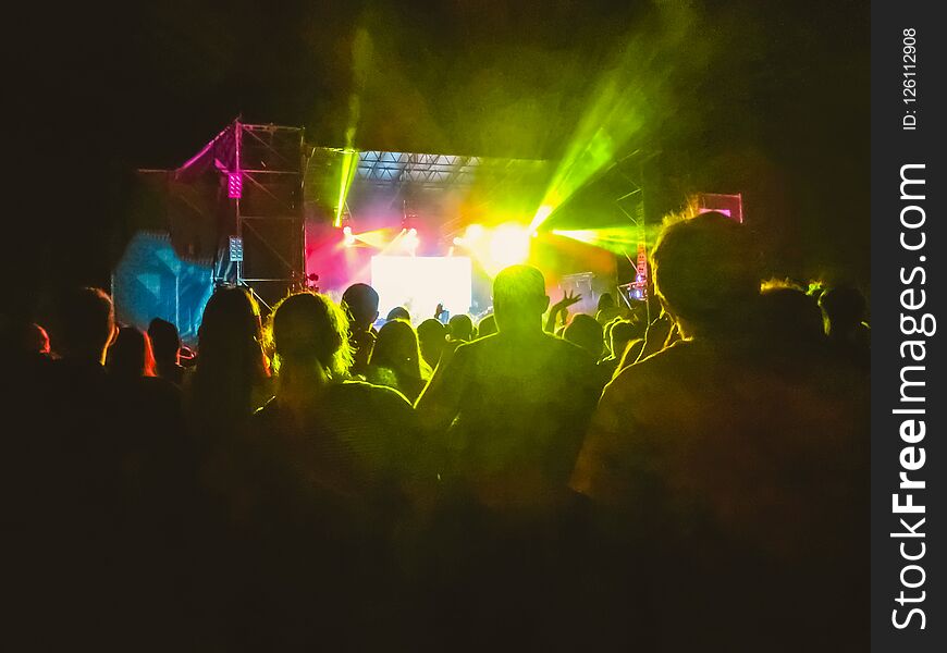 The party, concert concept. Crowd raising their hands and enjoying great rock festival. blur bokeh for background. The party, concert concept. Crowd raising their hands and enjoying great rock festival. blur bokeh for background.