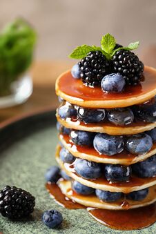 Tasty Pancakes With Berries And Syrup Stock Image