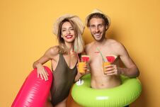 Happy Young Couple In Beachwear With Inflatable Rings Stock Photography