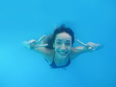 Beautiful Young Woman Swimming In Pool Stock Photography