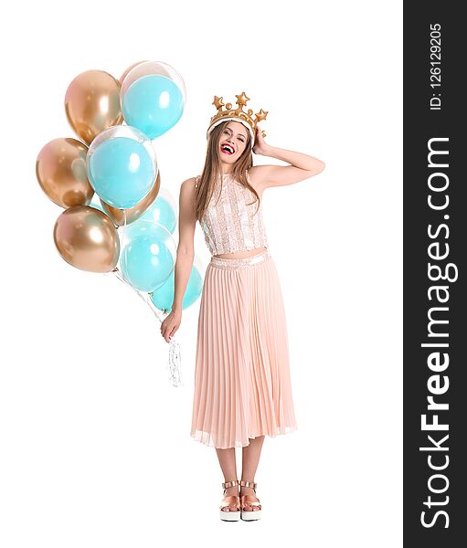 Young woman with crown and air balloons on white background